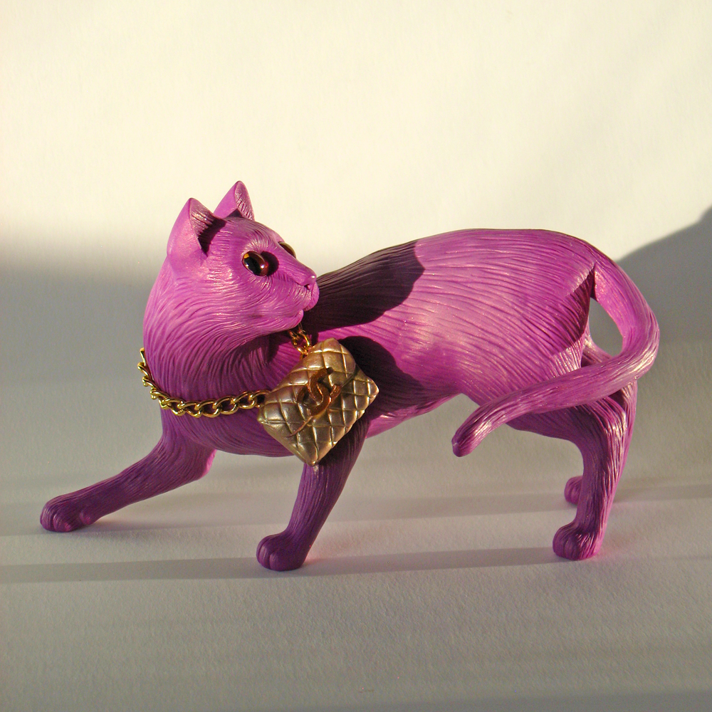 I sculpted this miniature pink kitty figurine from polymer clay. She carries a gold vintage Chanel purse around her neck. She is graceful in form, and looks back over her shoulder as though she might actually move. The pink and gold color combination of this OOAK original cat are quite dazzling together.